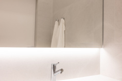 Taustavalaistu seinästä seinään ulottuva peili antaa tasaisen tunnelmavalon koko tilaan